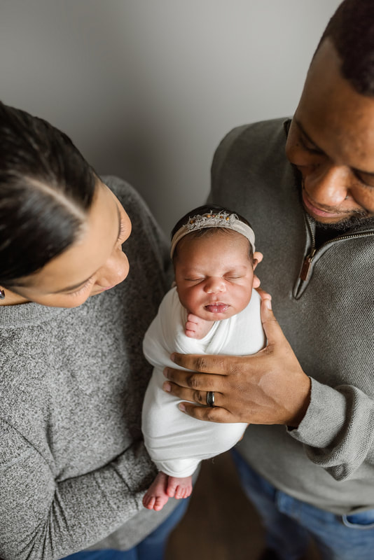 portrait of new parents with newborn baby in Memphis, TN
