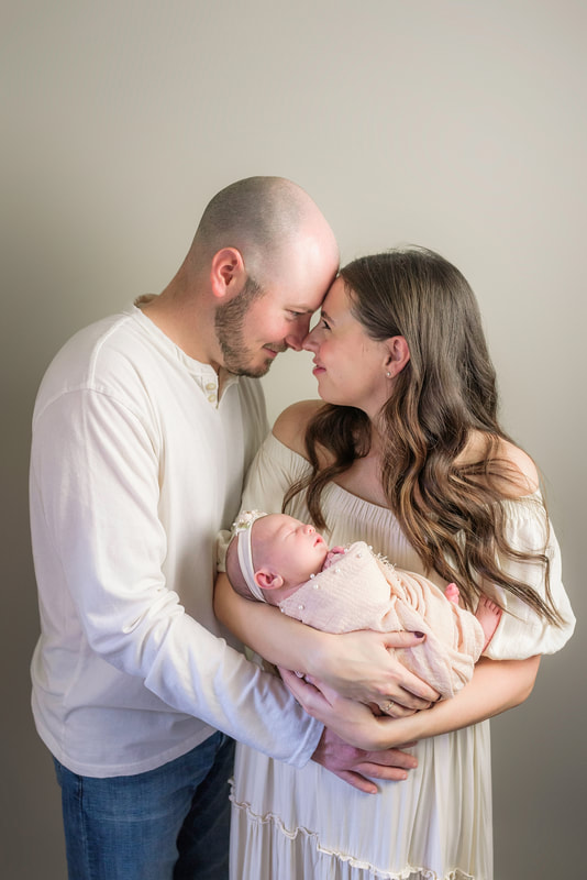 portrait of new parents with newborn baby in Memphis, TN