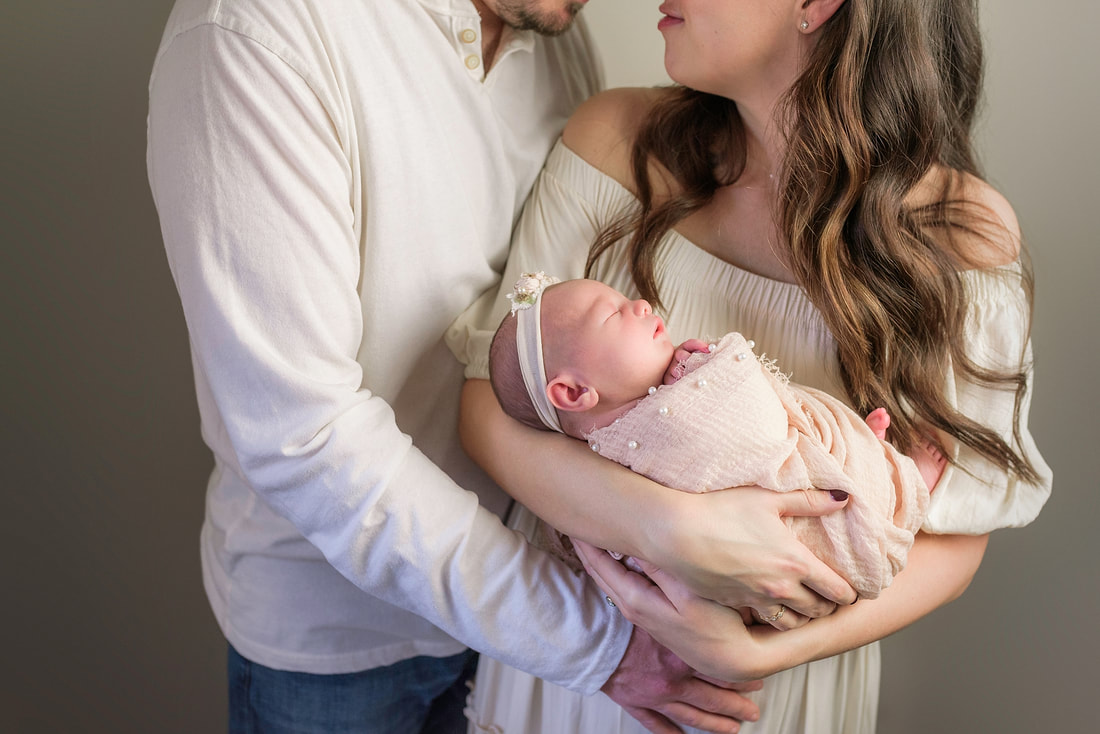 portrait of new parents with newborn baby in Memphis, TN
