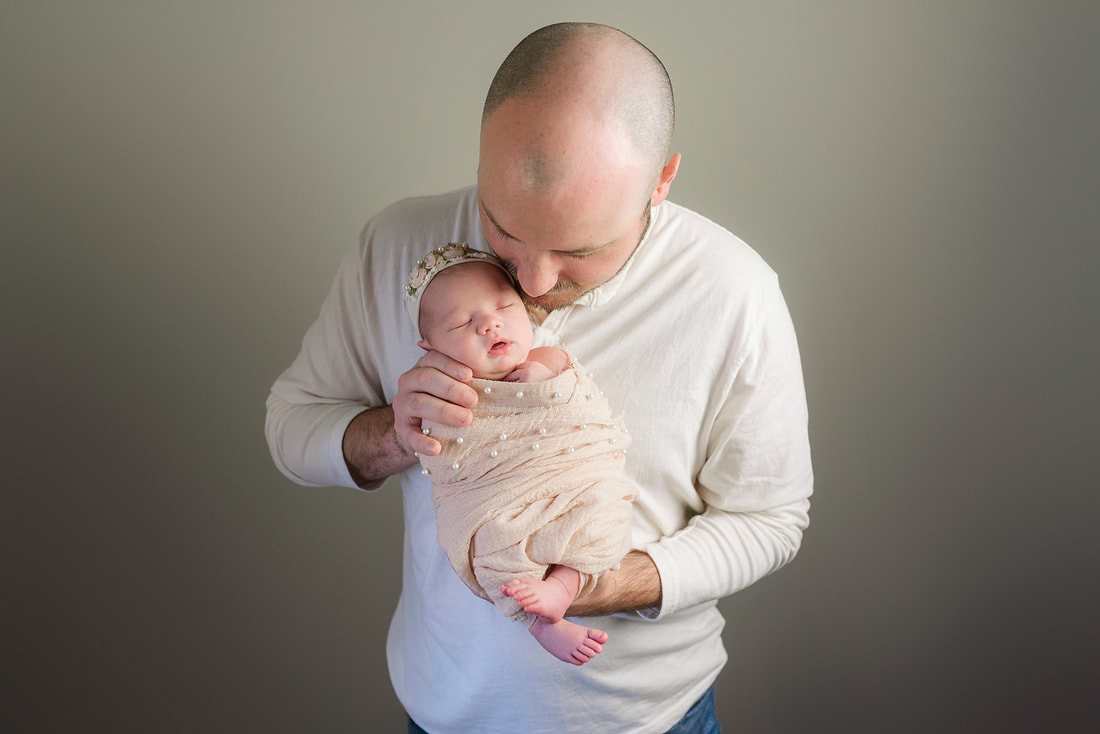 portrait of new parents with newborn baby in Memphis, TN