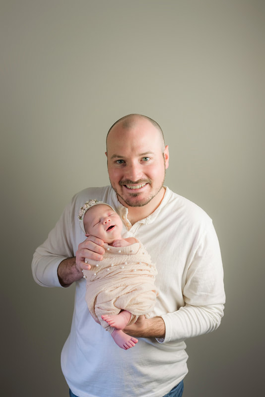 portrait of new parents with newborn baby in Memphis, TN